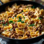 Plate of Garlic Butter Bowtie Pasta with Ground Beef garnished with parsley