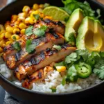 Delicious Mexican street corn chicken bowl topped with cilantro and lime.
