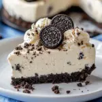 No-bake Fireworks Oreo cheesecake bars topped with colorful sprinkles and Oreo cookies.
