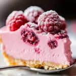 Delicious no bake raspberry cheesecake topped with fresh raspberries.
