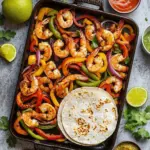 Colorful sheet pan shrimp fajitas with bell peppers and onions ready to serve