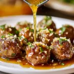 Slow Cooker Honey Garlic Meatballs in a bowl with a garnish