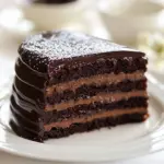 Slice of super moist chocolate dream cake topped with chocolate frosting